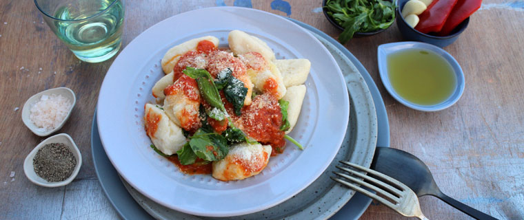 fluffy ricotta gnocchi, red pepper sauce and buttered spring greens